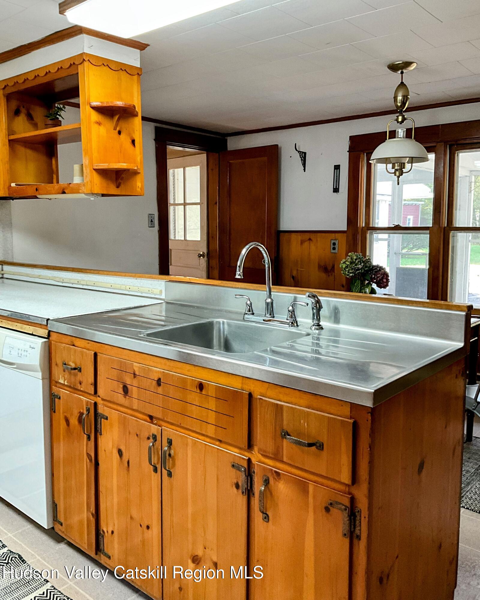729 Springtown Road Tillson, NY 12486 - Photo 20 of 52 a kitchen with stainless steel appliances granite countertop a sink dishwasher and cabinets with wooden floor