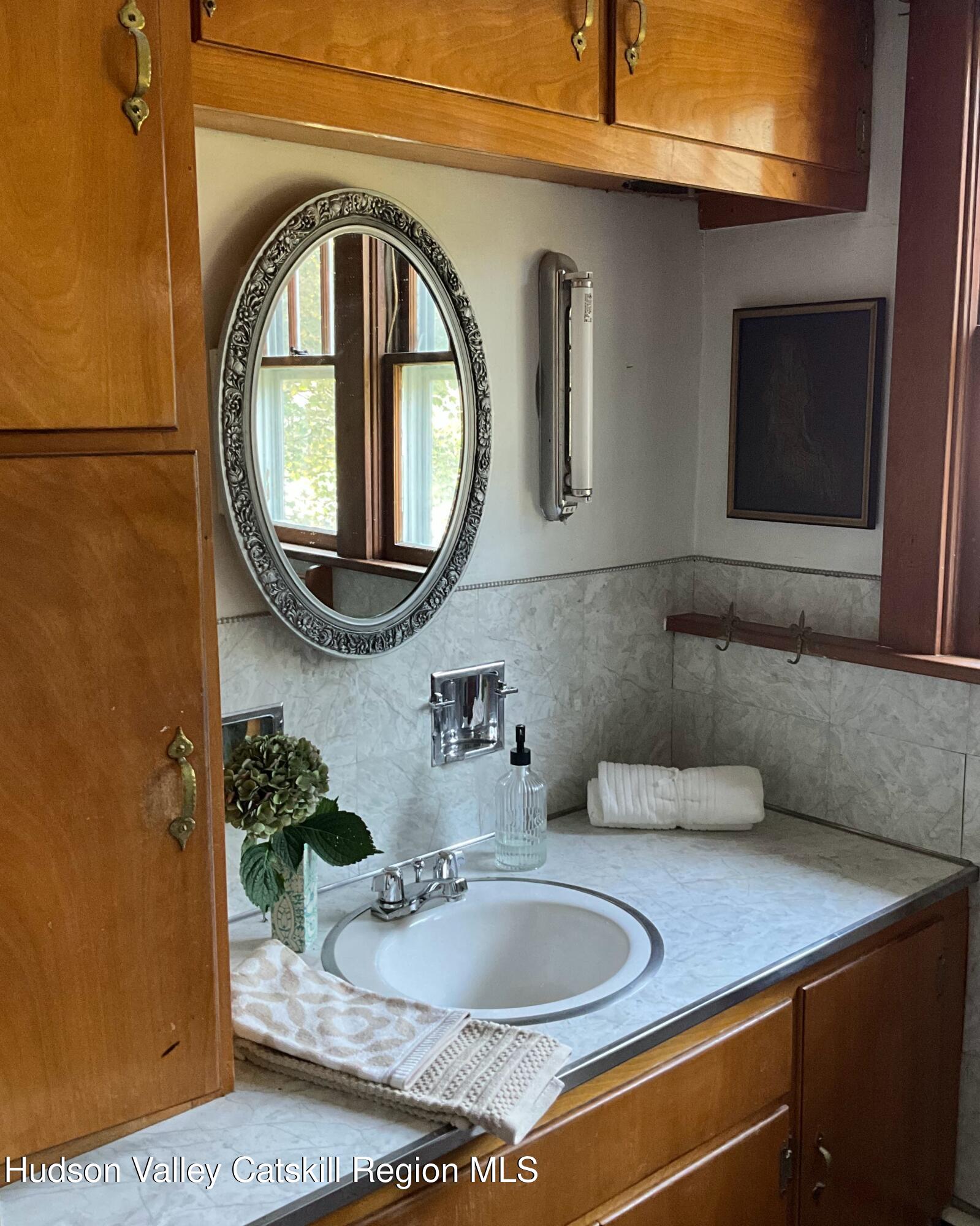 729 Springtown Road Tillson, NY 12486 - Photo 26 of 52 a bathroom with a sink and a mirror