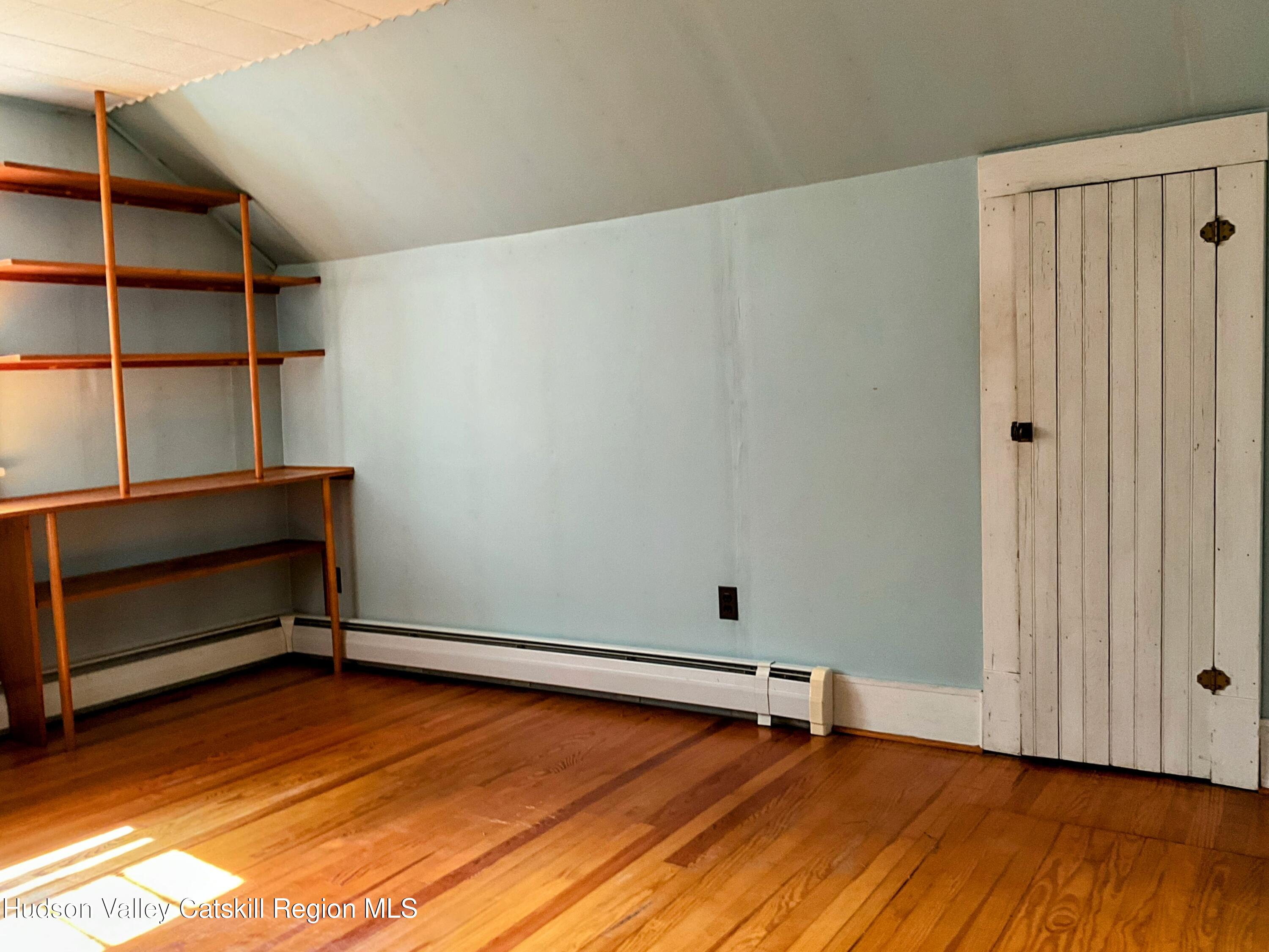 729 Springtown Road Tillson, NY 12486 - Photo 29 of 52 a view of an empty room with wooden floor and a window