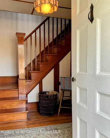 a view of entryway and hall with wooden floor