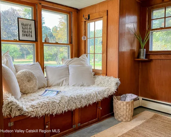a living room with furniture a piano and a potted plant