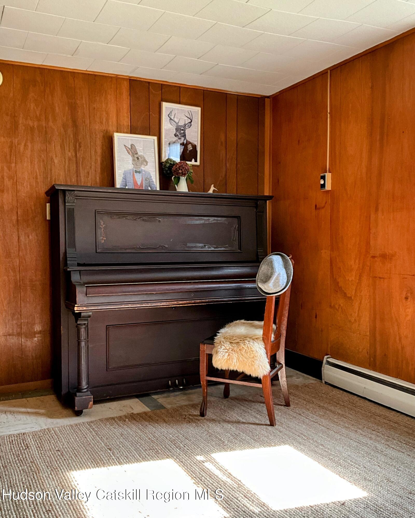729 Springtown Road Tillson, NY 12486 - Photo 36 of 52 a living room with furniture a piano and a potted plant