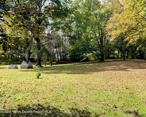 a view of yard with a house and a large tree