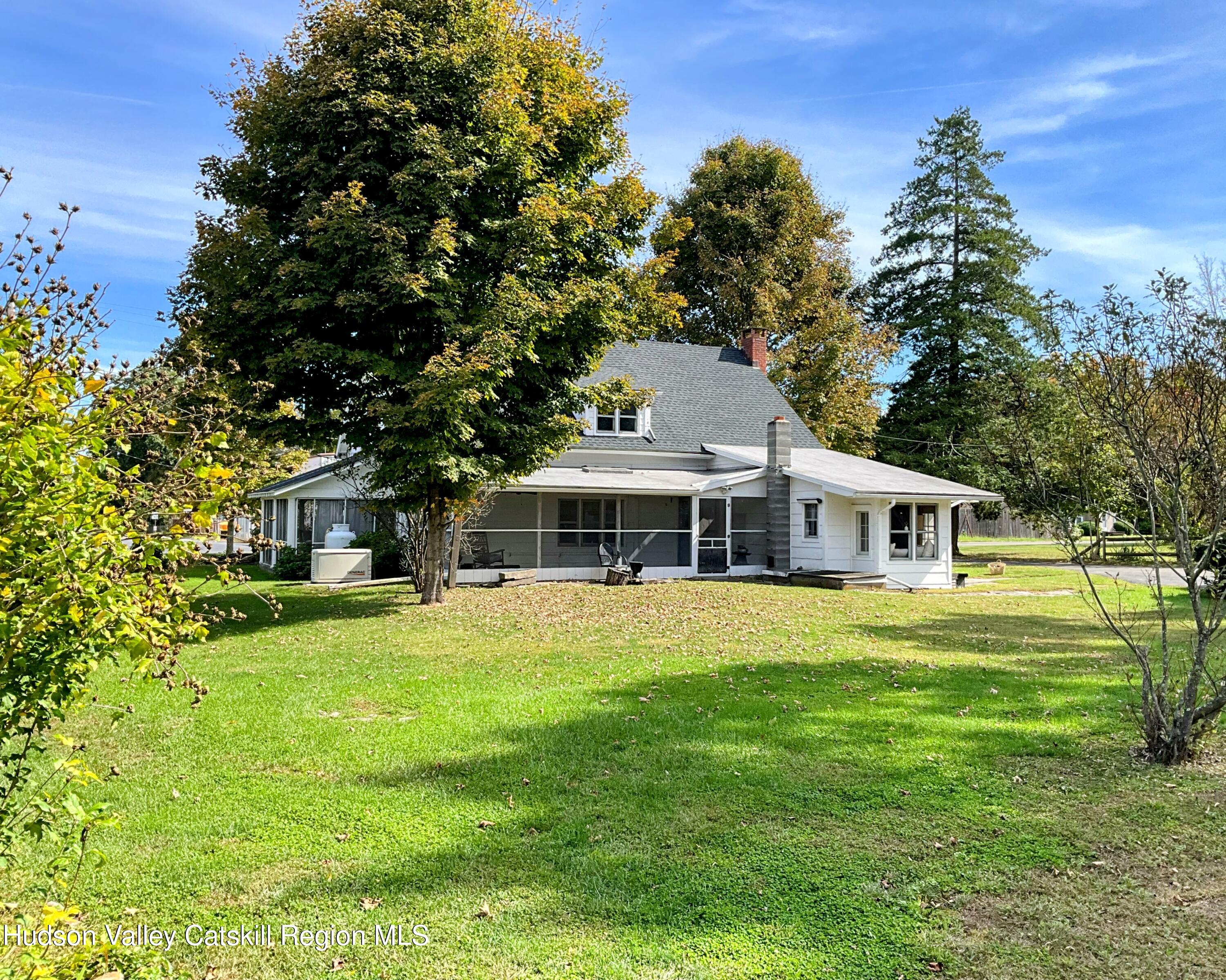 729 Springtown Road Tillson, NY 12486 - Photo 46 of 52 a front view of a house with a garden