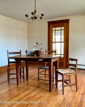 a view of a dining room with furniture and window