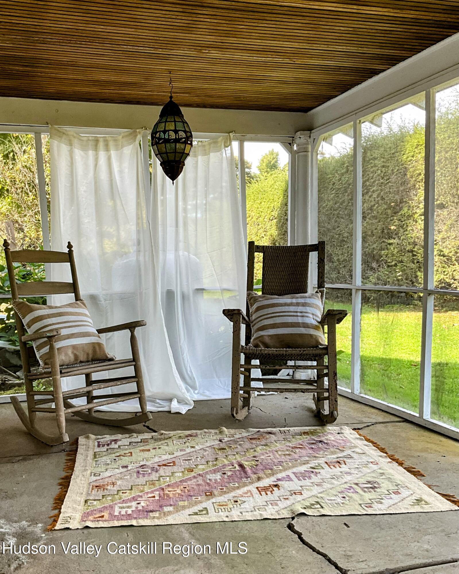 729 Springtown Road Tillson, NY 12486 - Photo 7 of 52 a living room with furniture and a floor to ceiling window