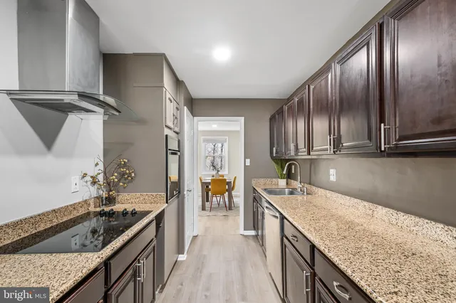 a kitchen with granite countertop stainless steel appliances window a sink and counter space