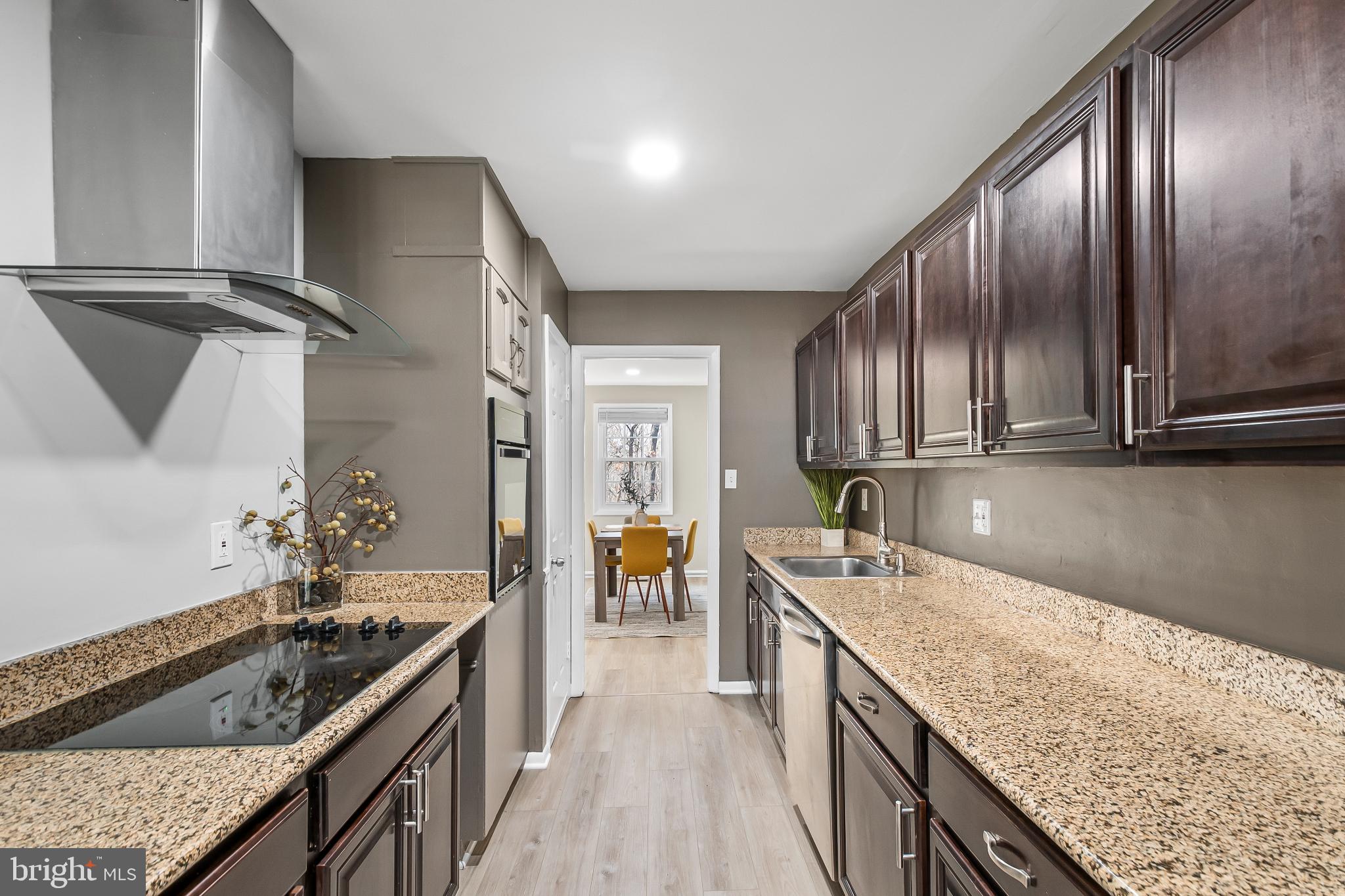 11867 Old Columbia Pike, Unit 75 Silver Spring, MD 20904 - Photo 11 of 41 a kitchen with granite countertop stainless steel appliances window a sink and counter space