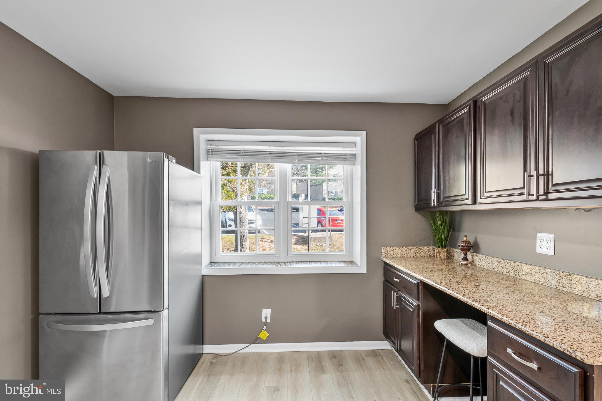 11867 Old Columbia Pike, Unit 75 Silver Spring, MD 20904 - Photo 12 of 41 a kitchen with stainless steel appliances granite countertop a refrigerator and a sink