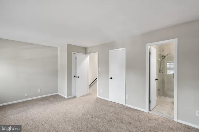 a view of an empty room and closet area