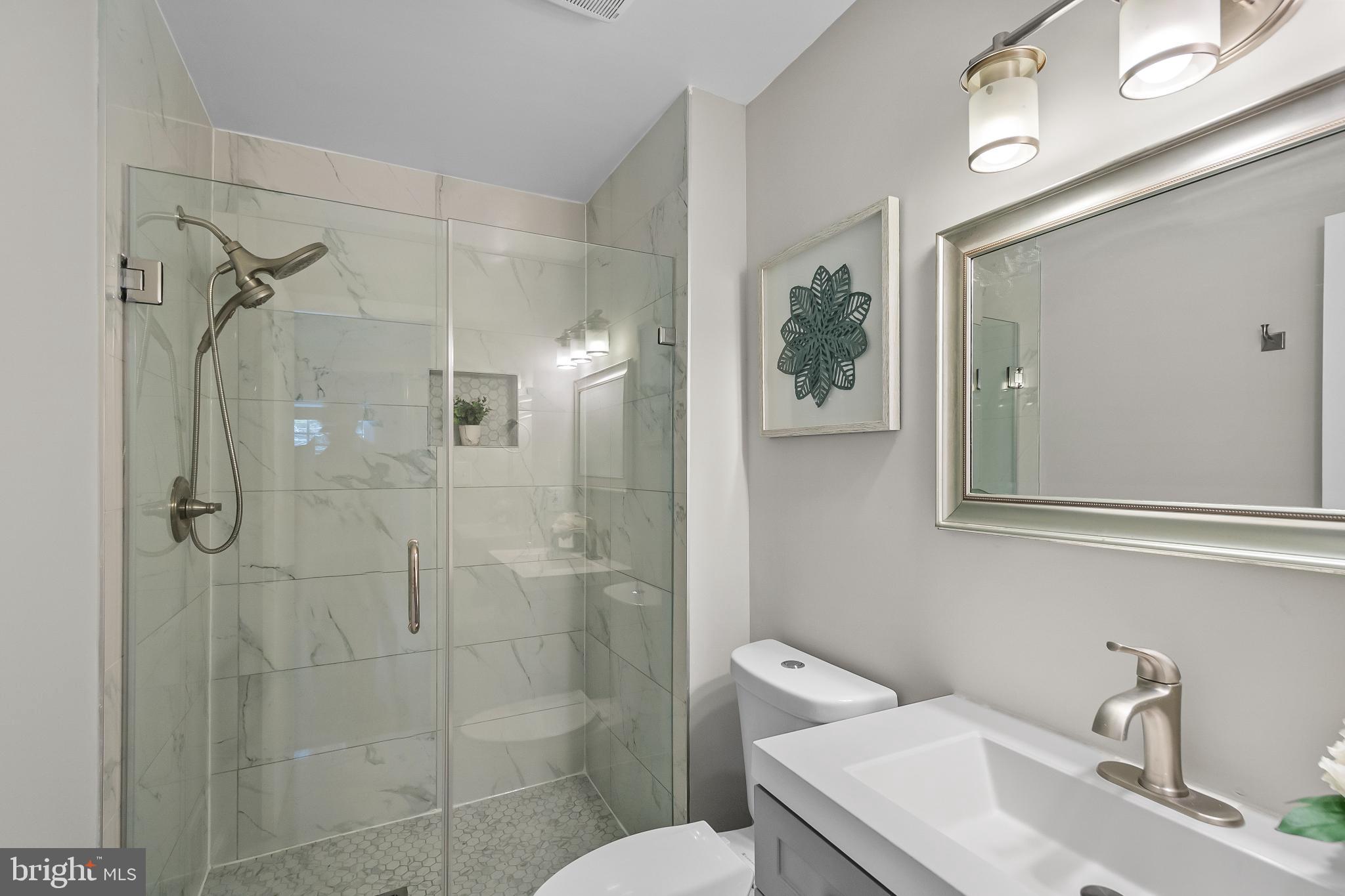 11867 Old Columbia Pike, Unit 75 Silver Spring, MD 20904 - Photo 18 of 41 a bathroom with a sink toilet and shower