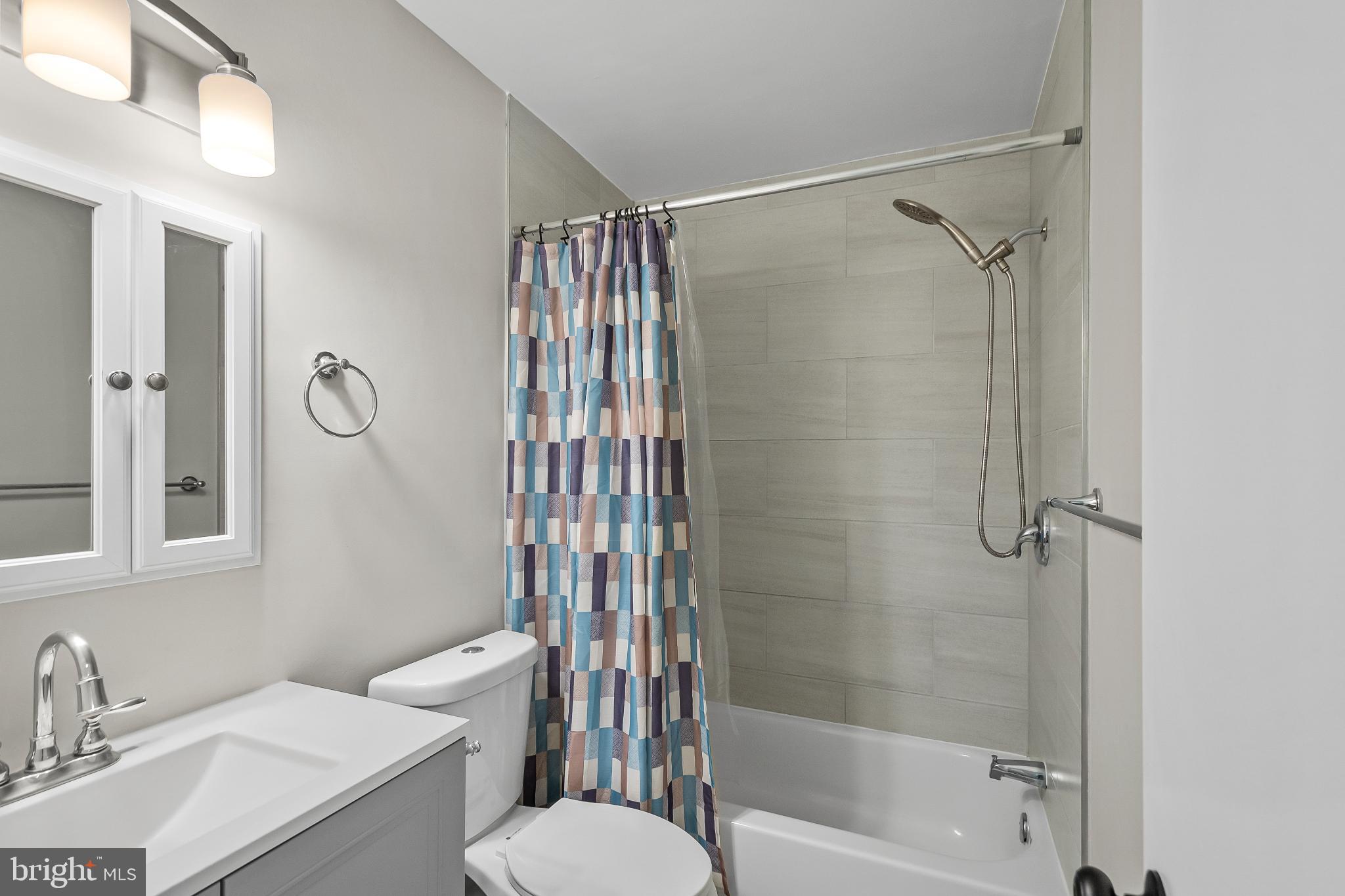 11867 Old Columbia Pike, Unit 75 Silver Spring, MD 20904 - Photo 21 of 41 a bathroom with a sink toilet and shower