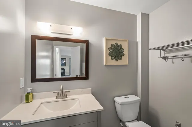 a bathroom with a toilet a sink and mirror