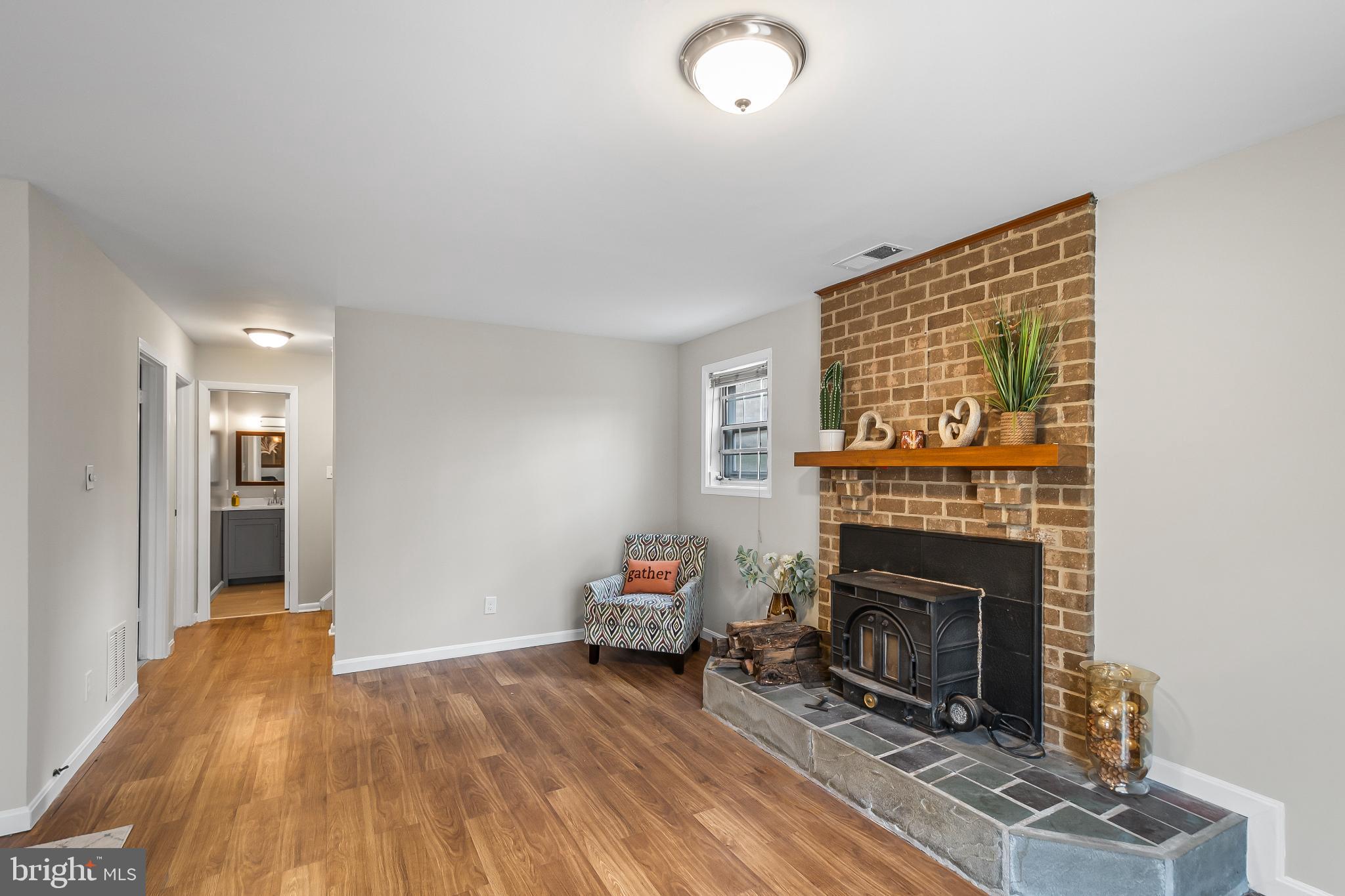 11867 Old Columbia Pike, Unit 75 Silver Spring, MD 20904 - Photo 31 of 41 a living room with furniture and a fireplace