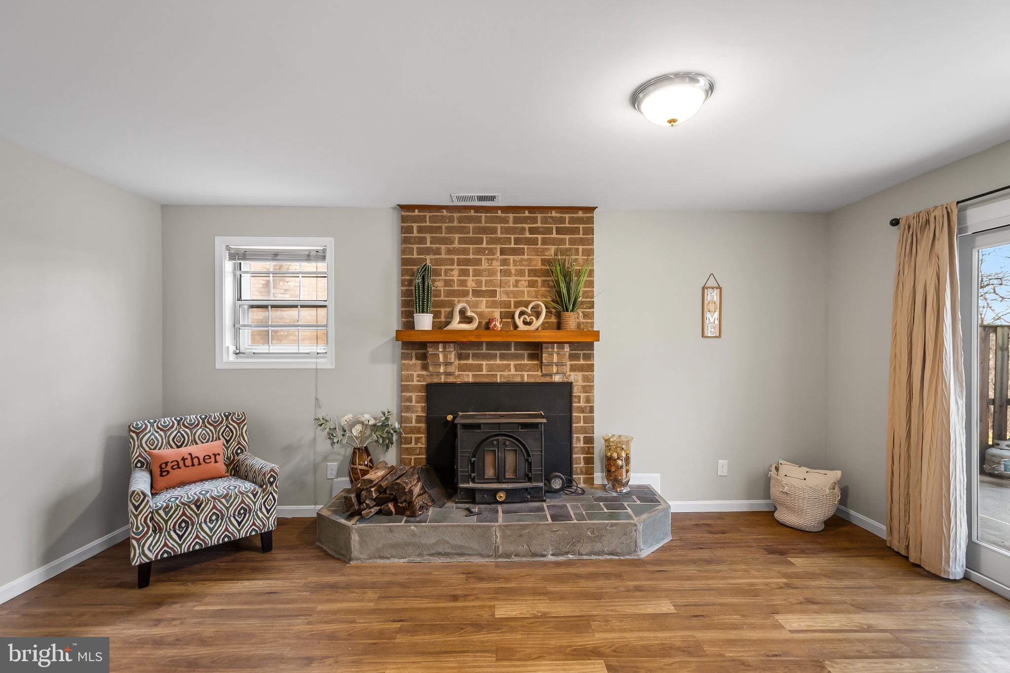 11867 Old Columbia Pike, Unit 75 Silver Spring, MD 20904 - Photo 32 of 41 a living room with furniture and a fireplace