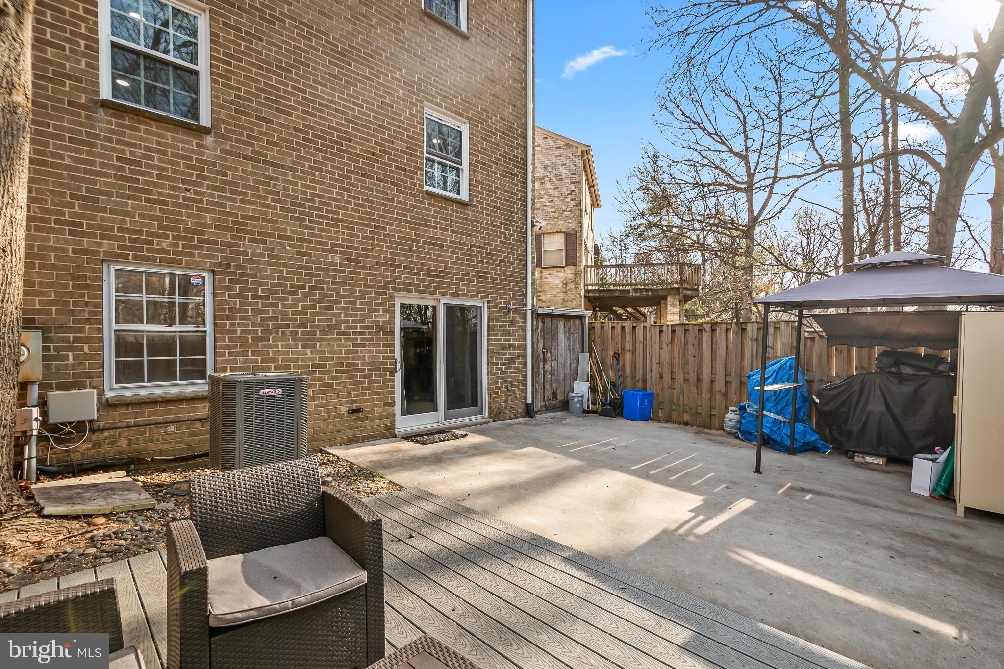 11867 Old Columbia Pike, Unit 75 Silver Spring, MD 20904 - Photo 35 of 41 a view of a patio with couches table and chairs with wooden fence