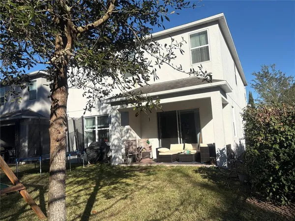 a view of a house with backyard porch and sitting area