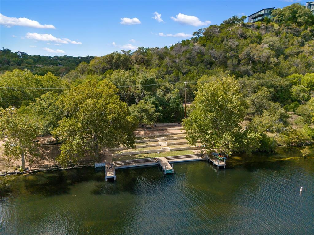 2210 Red Fox Road Austin, TX 78734 - Photo 4 of 40 A tranquil lakefront property featuring multiple boat docks and tiered terracing leading to the water's edge.