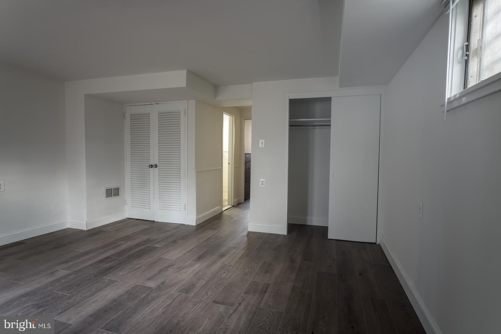 301 I Street Southwest, Unit 108 Washington, DC 20024 - Photo 16 of 66 an empty room with wooden floor and windows