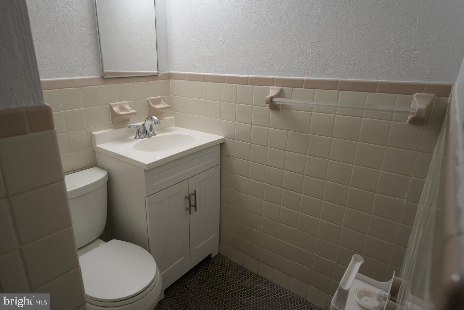 301 I Street Southwest, Unit 108 Washington, DC 20024 - Photo 17 of 66 a bathroom with a toilet a sink and mirror