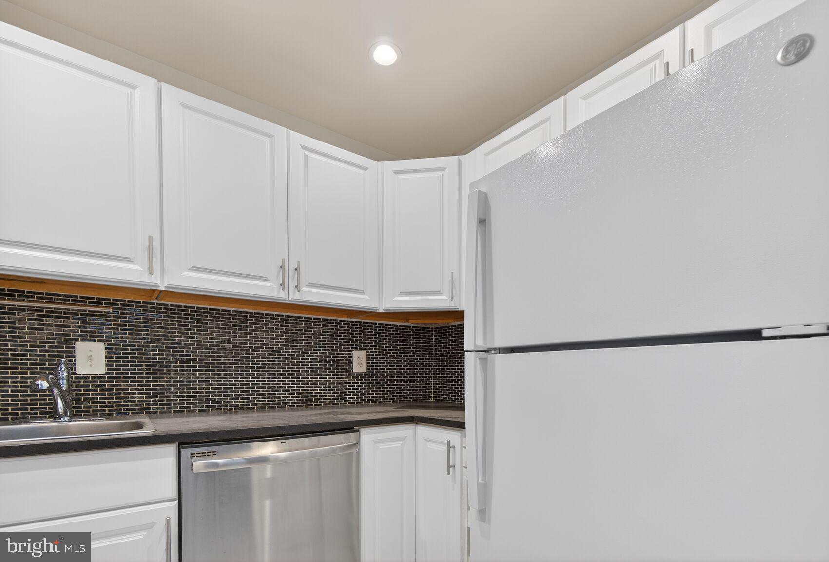 301 I Street Southwest, Unit 108 Washington, DC 20024 - Photo 38 of 66 a kitchen with cabinets and white stainless steel appliances