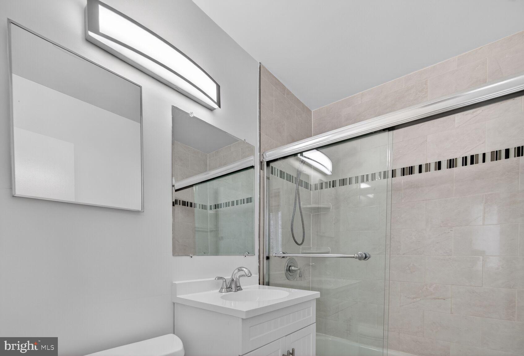 301 I Street Southwest, Unit 108 Washington, DC 20024 - Photo 39 of 66 a bathroom with a sink a shower and a mirror