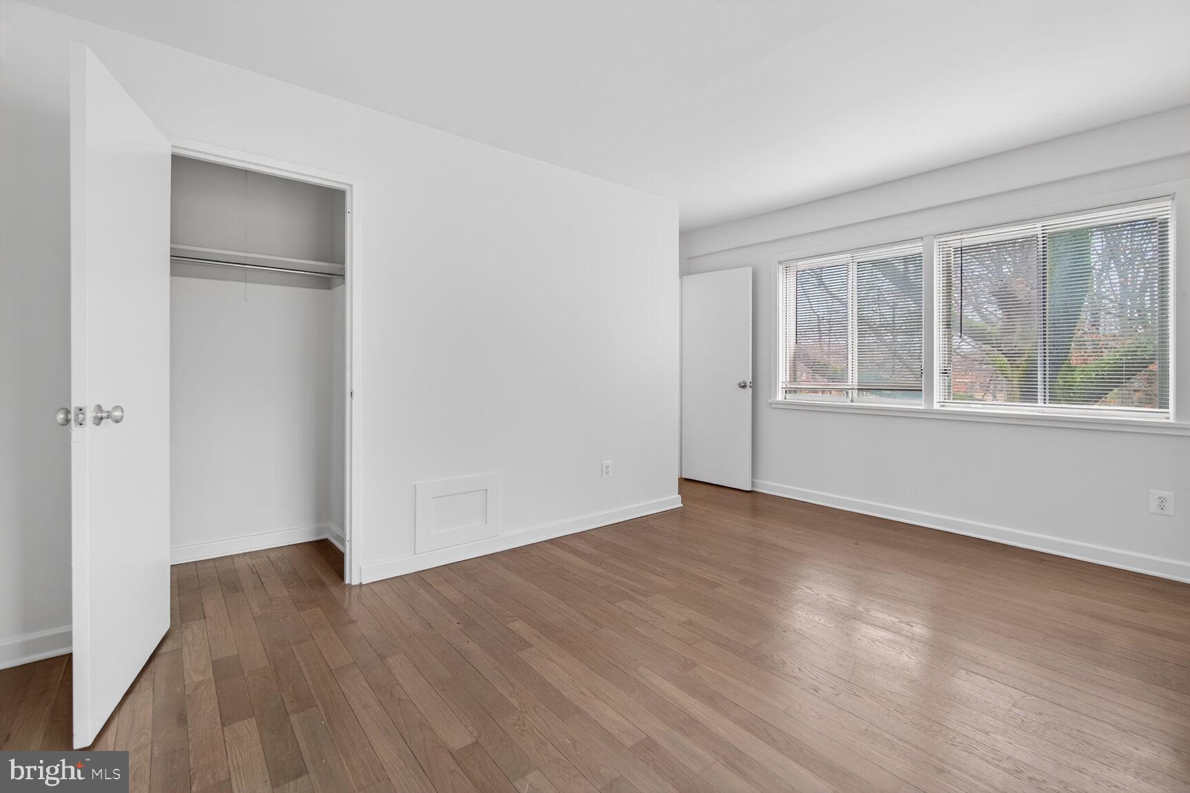 301 I Street Southwest, Unit 108 Washington, DC 20024 - Photo 41 of 66 an empty room with wooden floor and windows