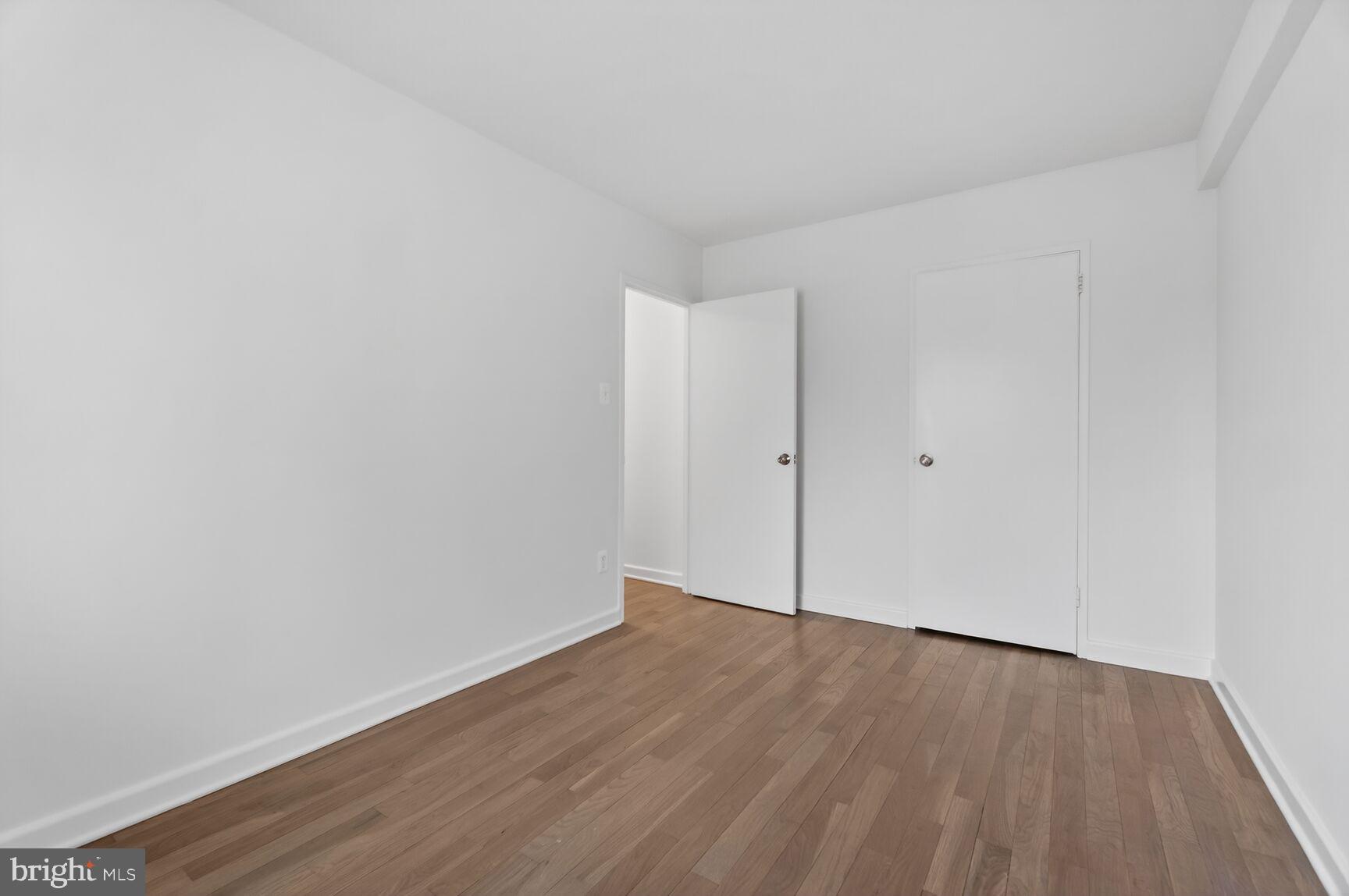 301 I Street Southwest, Unit 108 Washington, DC 20024 - Photo 43 of 66 a view of an empty room with wooden floor