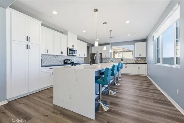 a view of kitchen with center island and stainless steel appliances