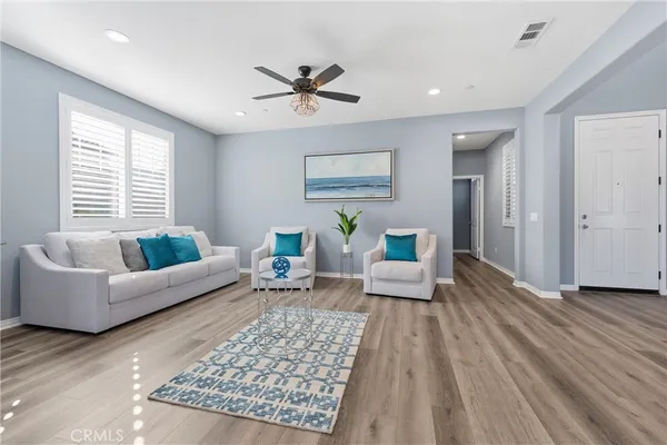 a living room with furniture and a wooden floor