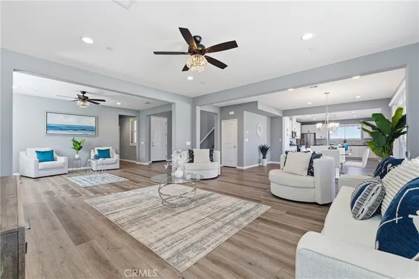 a living room with furniture and wooden floor