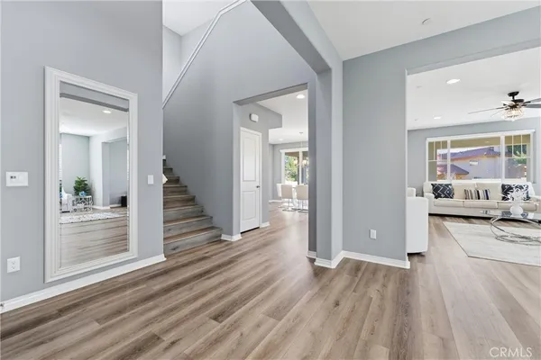 a view of a hallway view with wooden floor and dining room