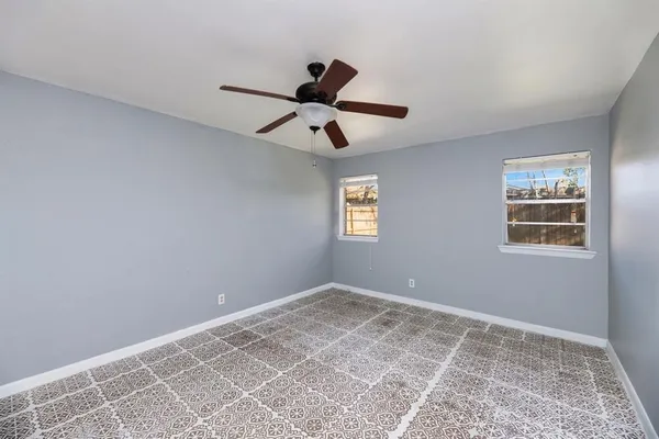 a view of room with hardwood floor and ceiling fan