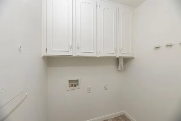 a view of storage and utility room with window