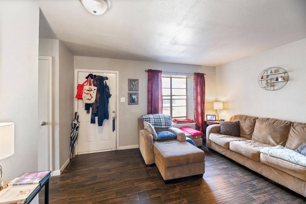 540 Billie Ruth Lane Hurst, TX 76053 - Photo 25 of 40 Living room featuring dark wood finished floors and baseboards