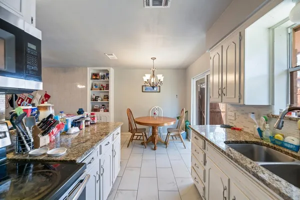 a view of a kitchen area with stainless steel appliances granite countertop lots of counter top space