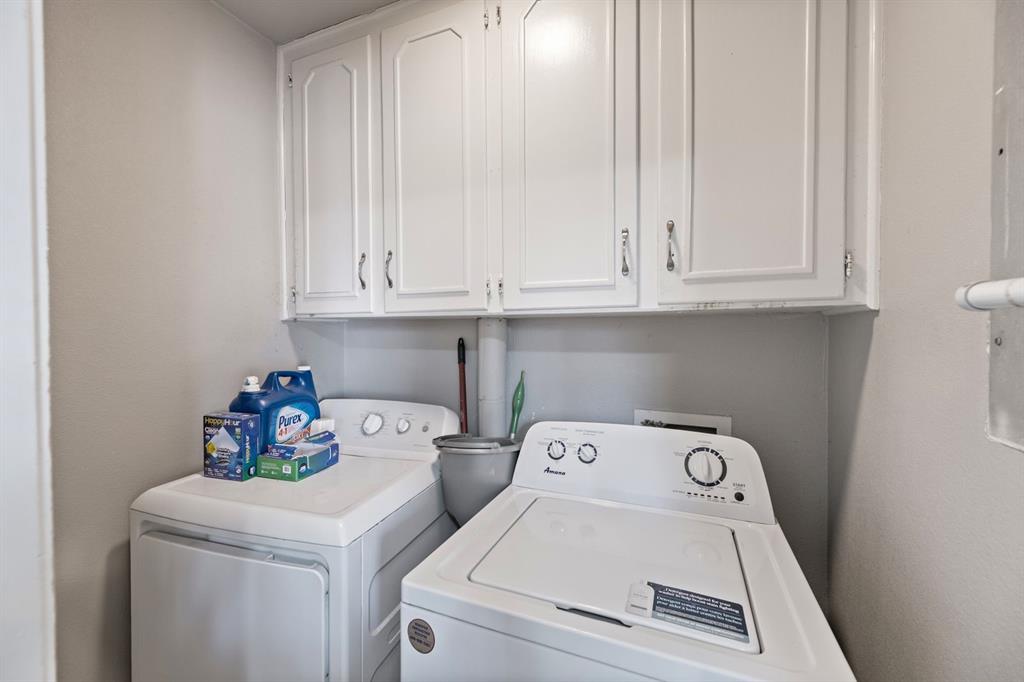 540 Billie Ruth Lane Hurst, TX 76053 - Photo 33 of 40 Laundry area with cabinet space and washing machine and dryer
