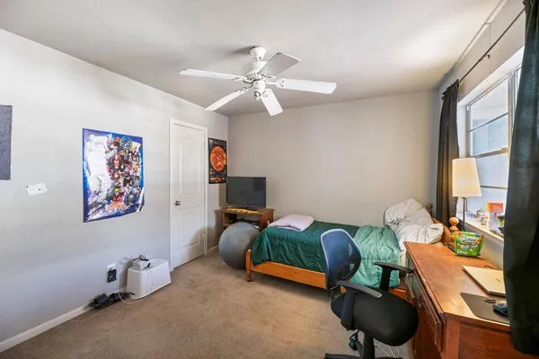 a bedroom with furniture and a window