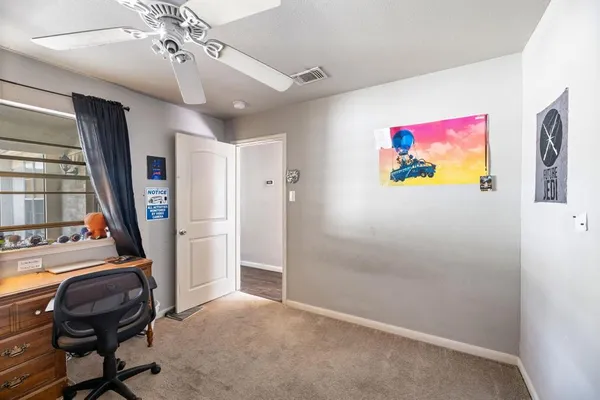 a view of a hallway with workspace and window