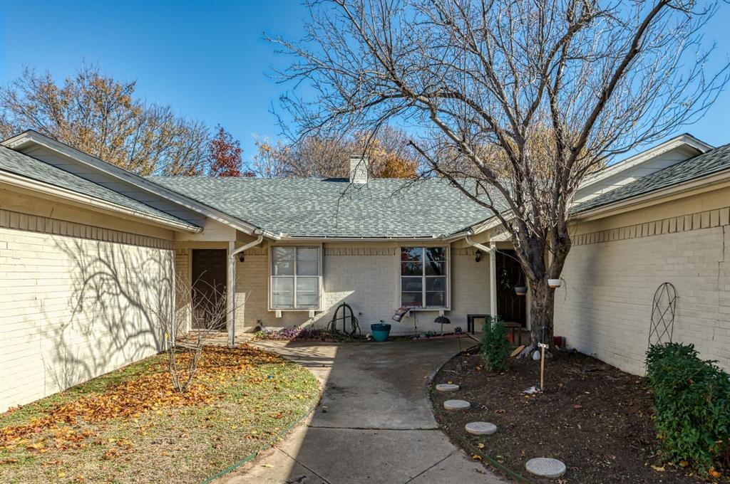 540 Billie Ruth Lane Hurst, TX 76053 - Photo 5 of 40 Property entrance featuring roof with shingles, brick siding, and a chimney