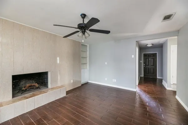 a view of an empty room and fire place