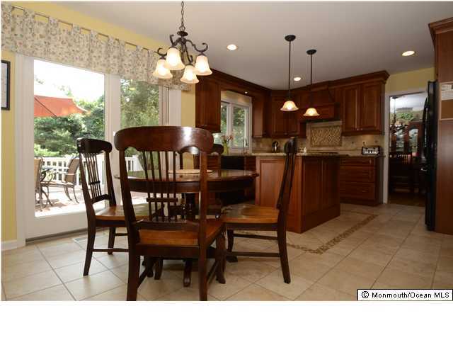 89 Ballantine Road Middletown, NJ 07748 - Photo 3 of 3 a dining room filled with furniture a window and a kitchen view