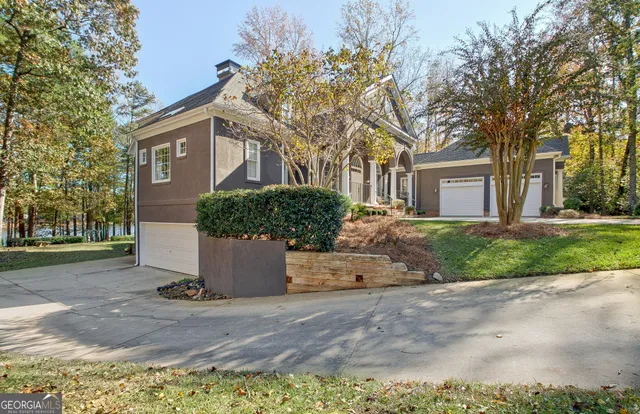 a view of a house with backyard and a garage