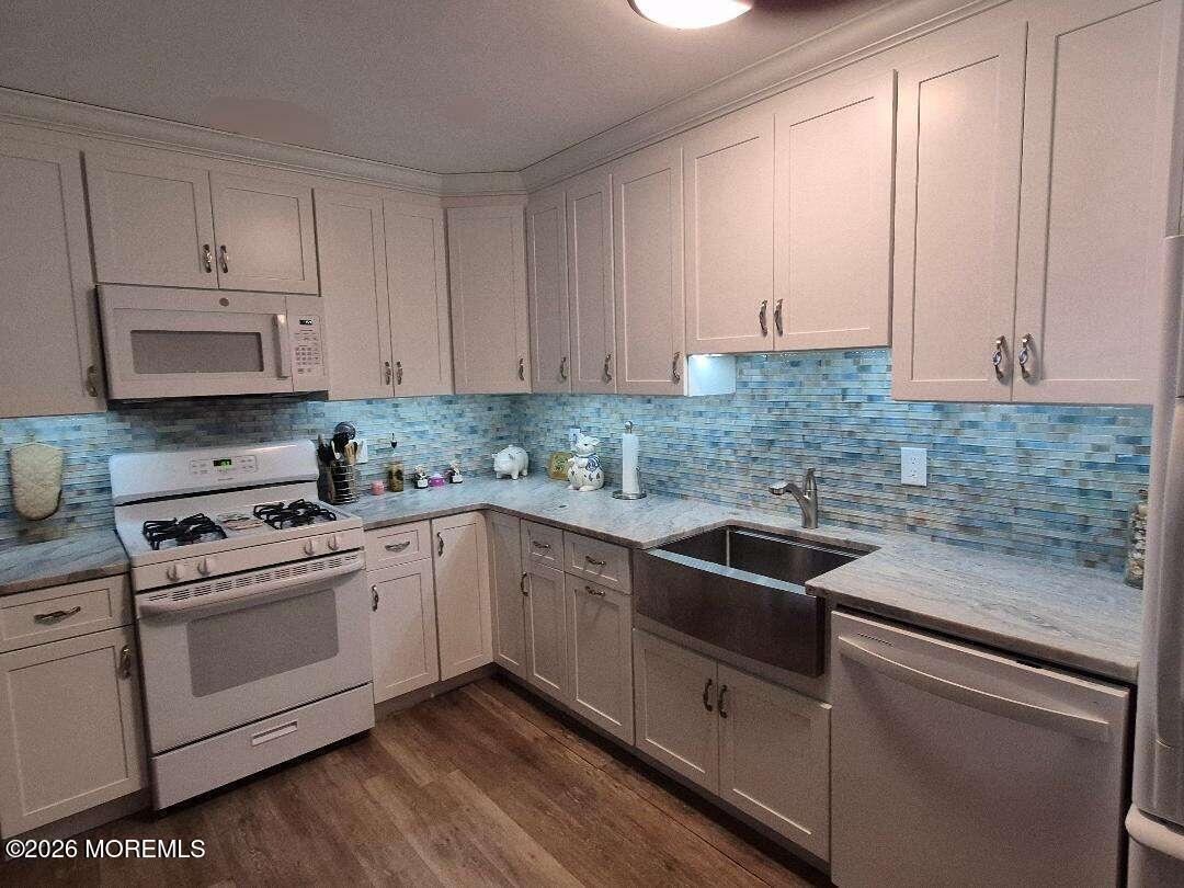 27 B Cedar Street Toms River, NJ 08757 - Photo 2 of 14 a kitchen with white cabinets and white appliances