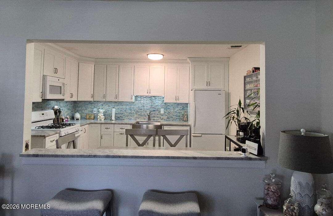 27 B Cedar Street Toms River, NJ 08757 - Photo 9 of 14 a kitchen with a sink and cabinets