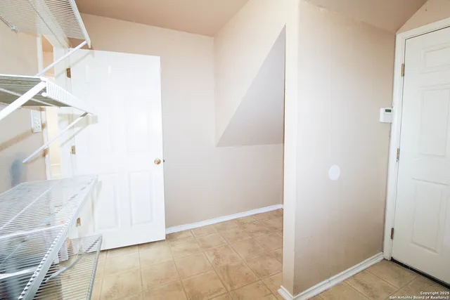 an empty room with windows and closet