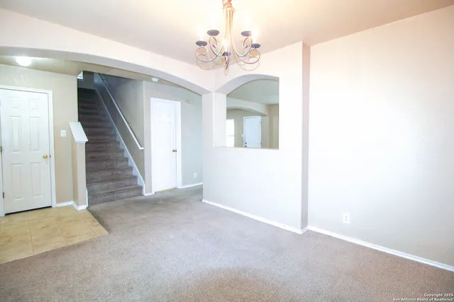a view of a livingroom with a chandelier fan