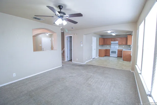 a view of a livingroom with a ceiling fan and a window