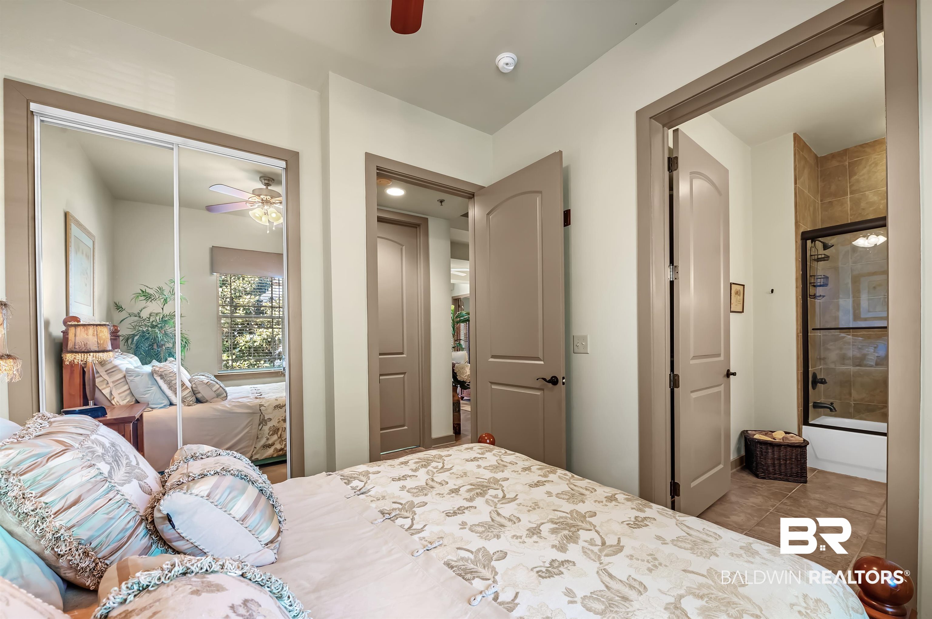 1430 Regency Road, Unit A301 Gulf Shores, AL 36542 - Photo 29 of 47 Bedroom featuring a closet, ceiling fan, and light tile patterned flooring