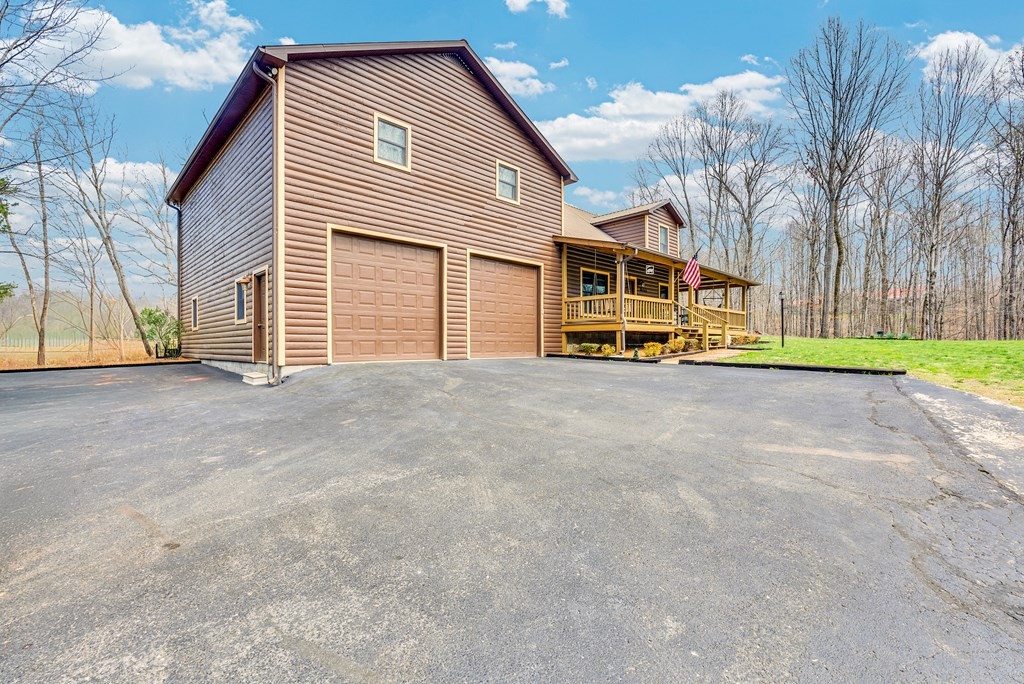465 Hickory Lane Sparta, TN 38583 - Photo 2 of 46 a front view of a house with a yard and garage